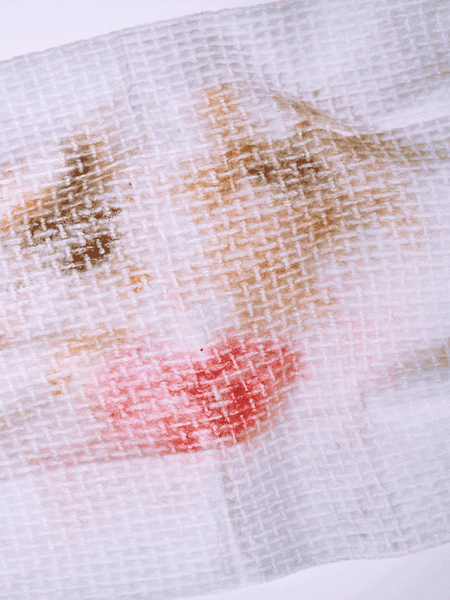 White wipe with make up showing through the textured fabric.